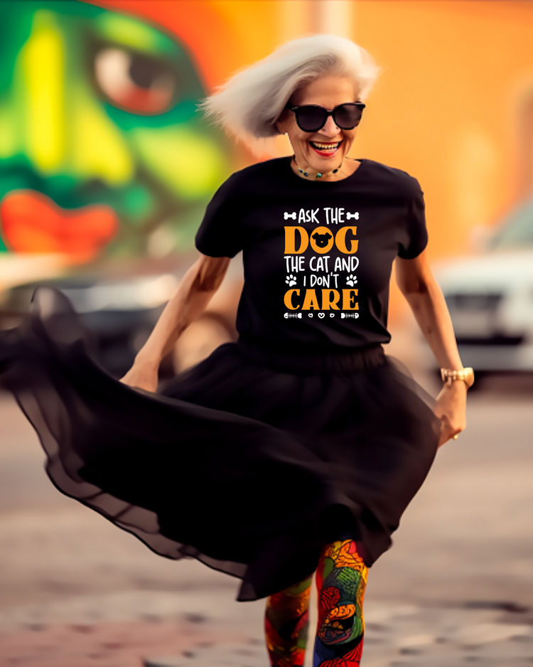 Woman wearing black t-shirt and tutu with bright graphic t-shirt. Smiling and walking outdoors.