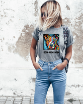 A person wearing a gray t-shirt with a colorful dog graphic and the text &