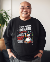 An older man wearing a black crewneck sweatshirt with a graphic text and a cartoon illustration.