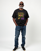 Man wearing a black t-shirt with colorful text "sex, drugs, rock-roll have a whole different meaning when you hit 66" on a white background