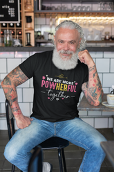 Man sitting in a cafe wearing a black t-shirt with a colorful message.