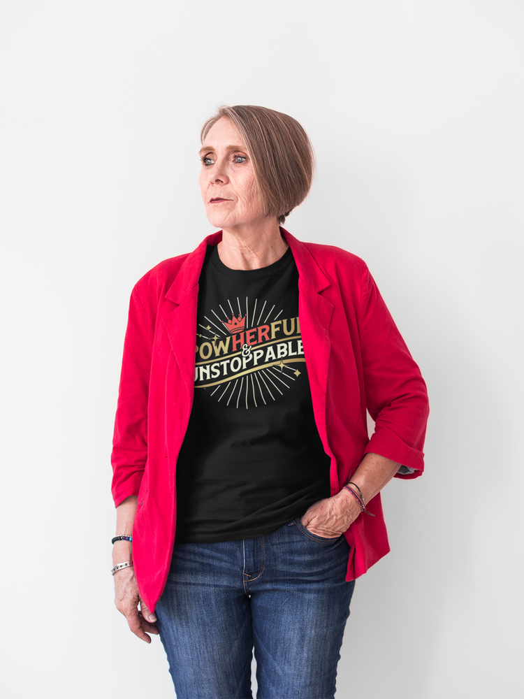 Woman wearing a red jacket over a black t-shirt with motivational text, standing against a white background