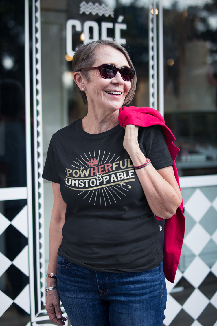Woman wearing a black t-shirt with motivational text, standing in front of a store entrance.