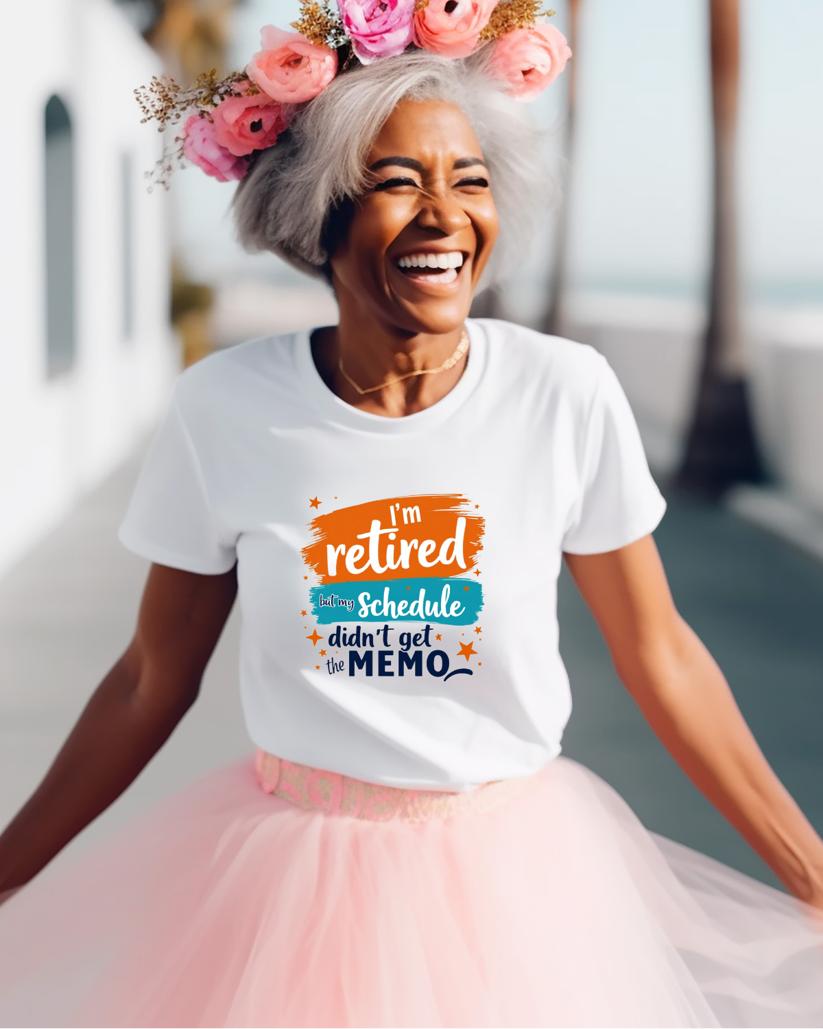 Woman wearing a white t-shirt with a humorous graphic.  She is smiling and happy.  