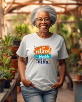 Woman wearing a white t-shirt with a humorous retirement message in a garden setting