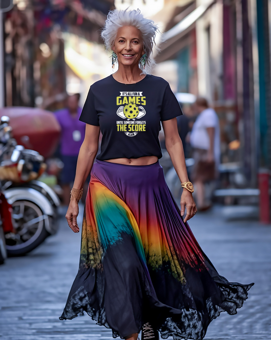A person wearing a black and multicolored skirt with a colorful top featuring text about pickleball.