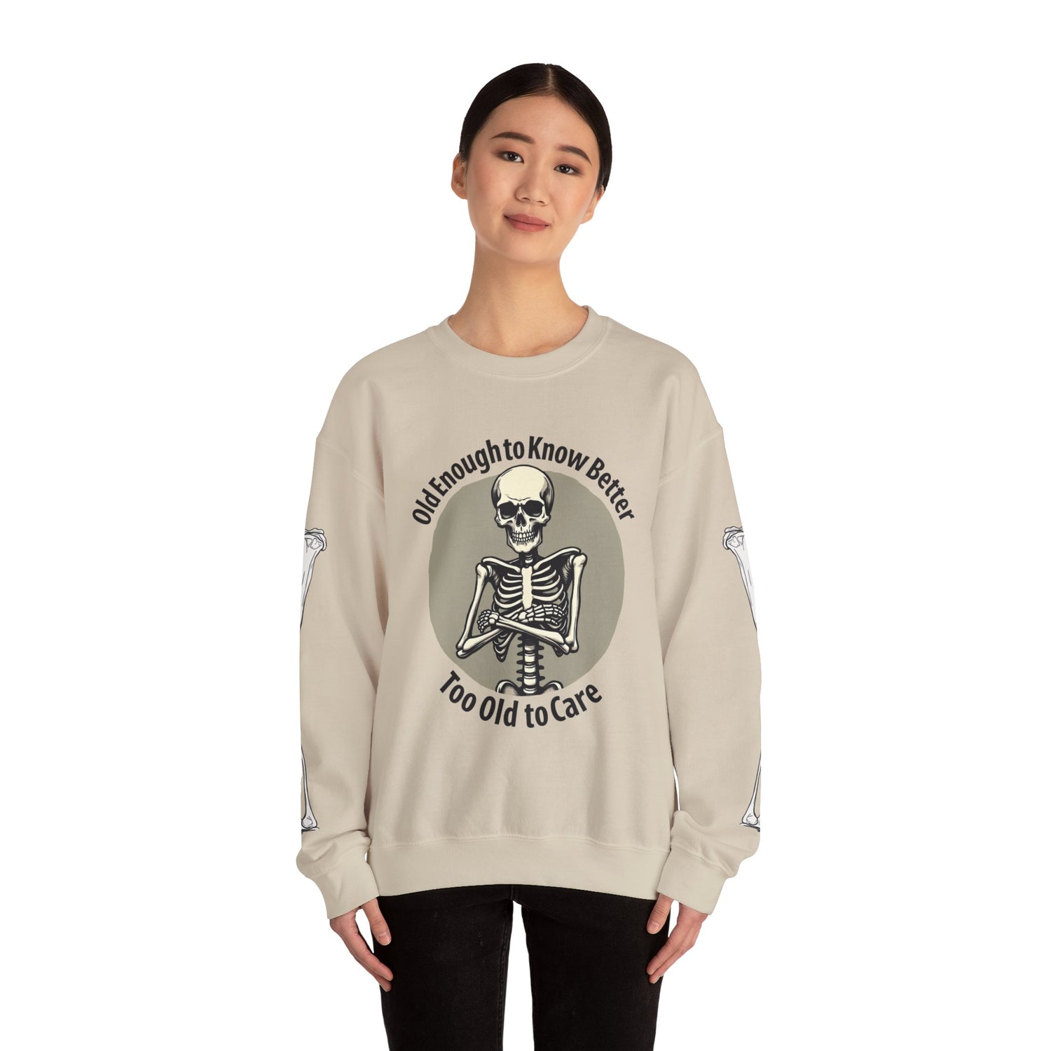 Beige sweatshirt with skeleton design and text worn by a model on a white background