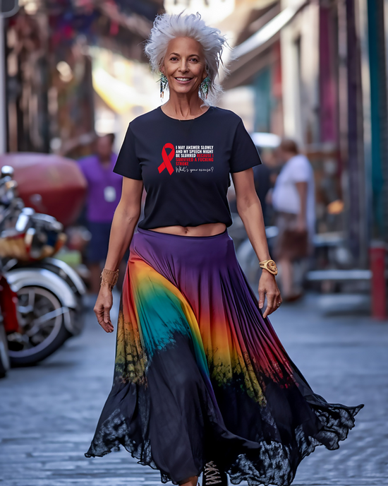 Woman wearing black t-shirt white graphic with text about strokes and  bright skirt